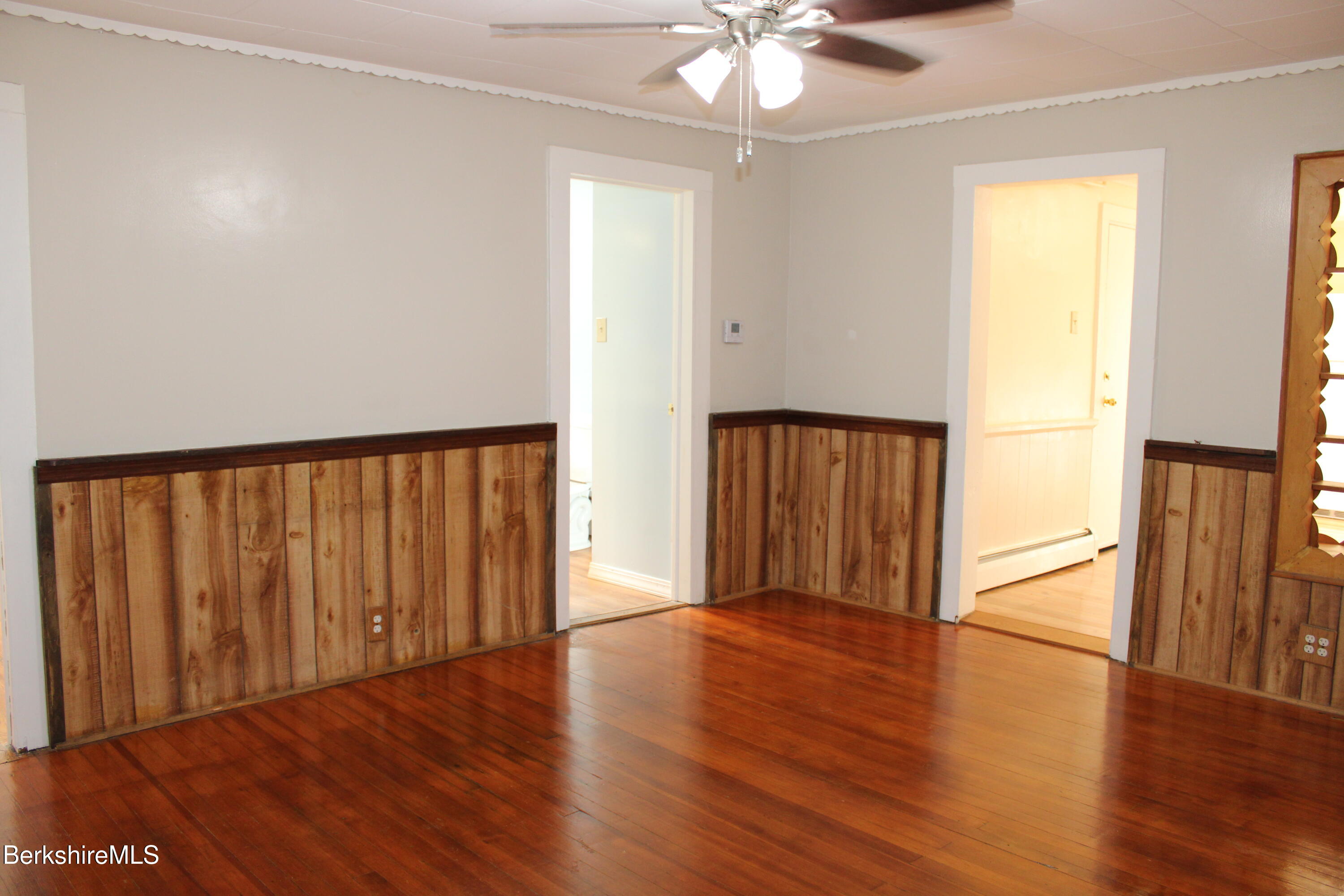 3-5 Pleasant Street Pittsfield, MA 01201 - Photo 5 of 40 an empty room with wooden floor chandelier fan and windows