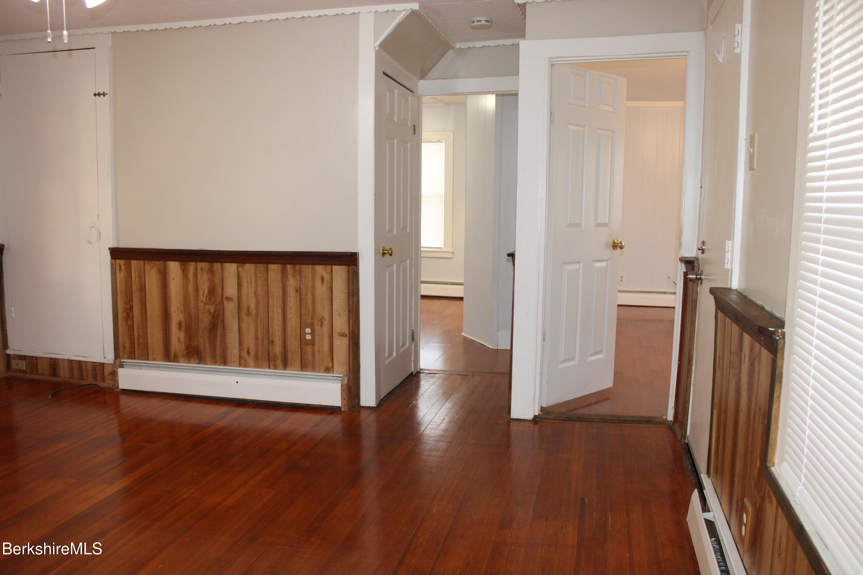 3-5 Pleasant Street Pittsfield, MA 01201 - Photo 6 of 40 a view of an empty room with wooden floor and a window
