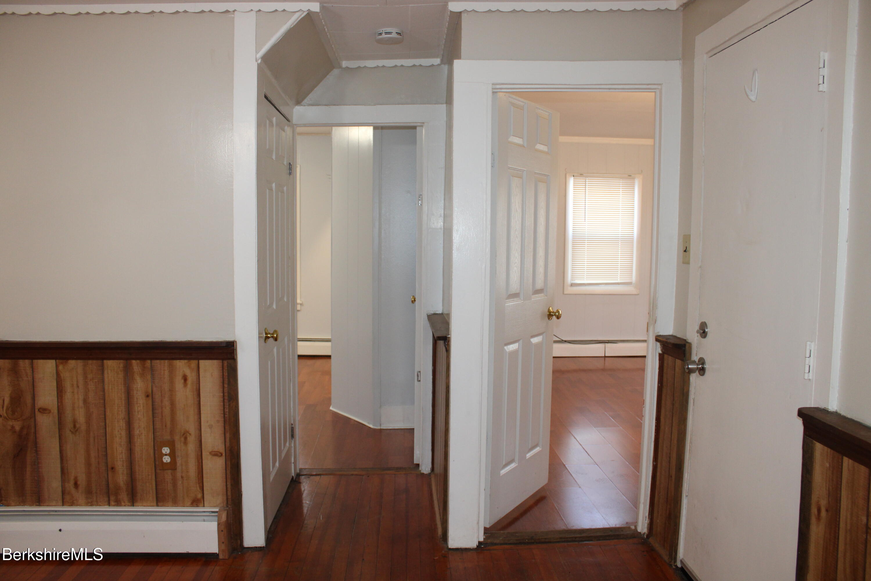 3-5 Pleasant Street Pittsfield, MA 01201 - Photo 8 of 40 a view of a hallway with wooden floor