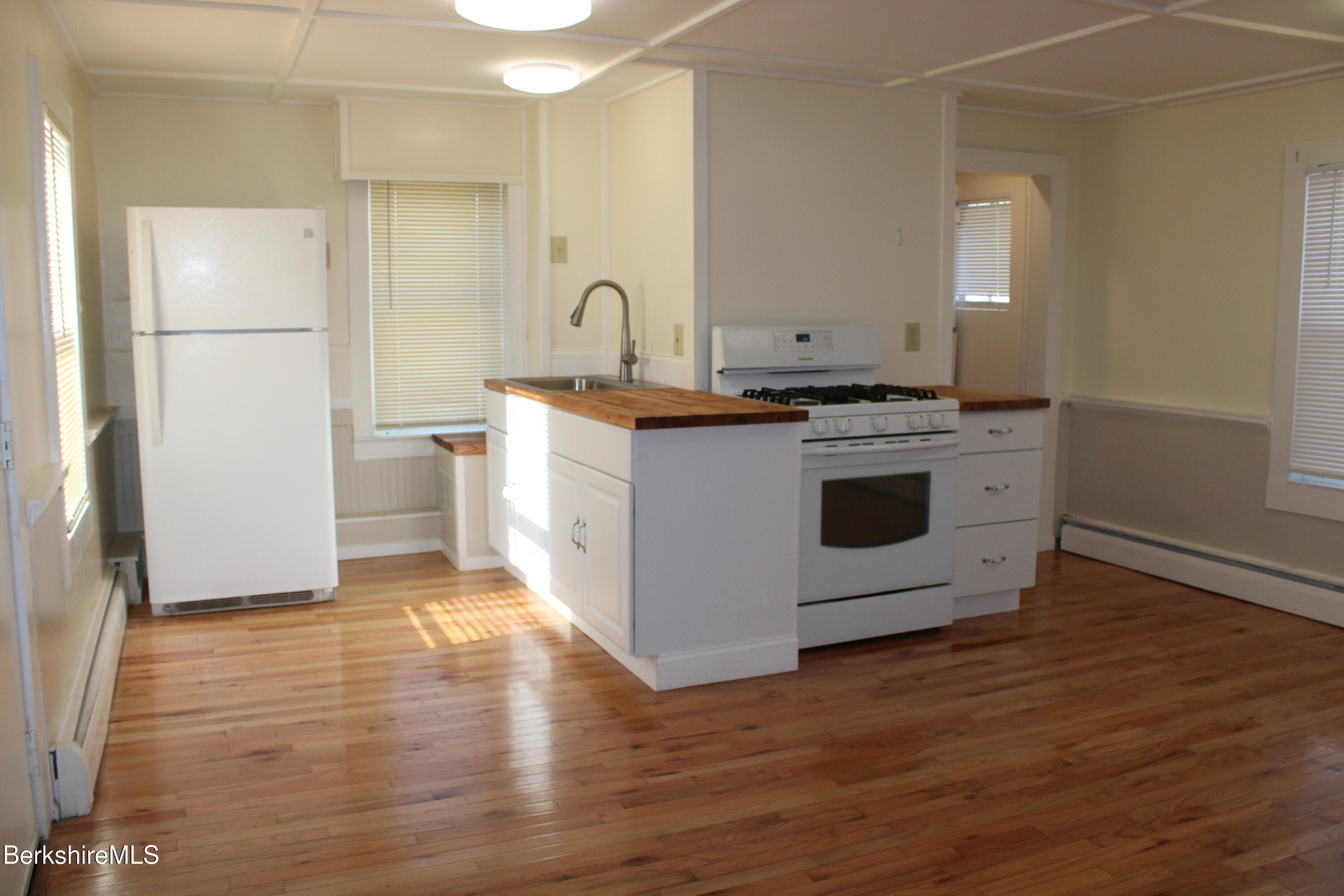 3-5 Pleasant Street Pittsfield, MA 01201 - Photo 9 of 40 a kitchen with a stove and a refrigerator