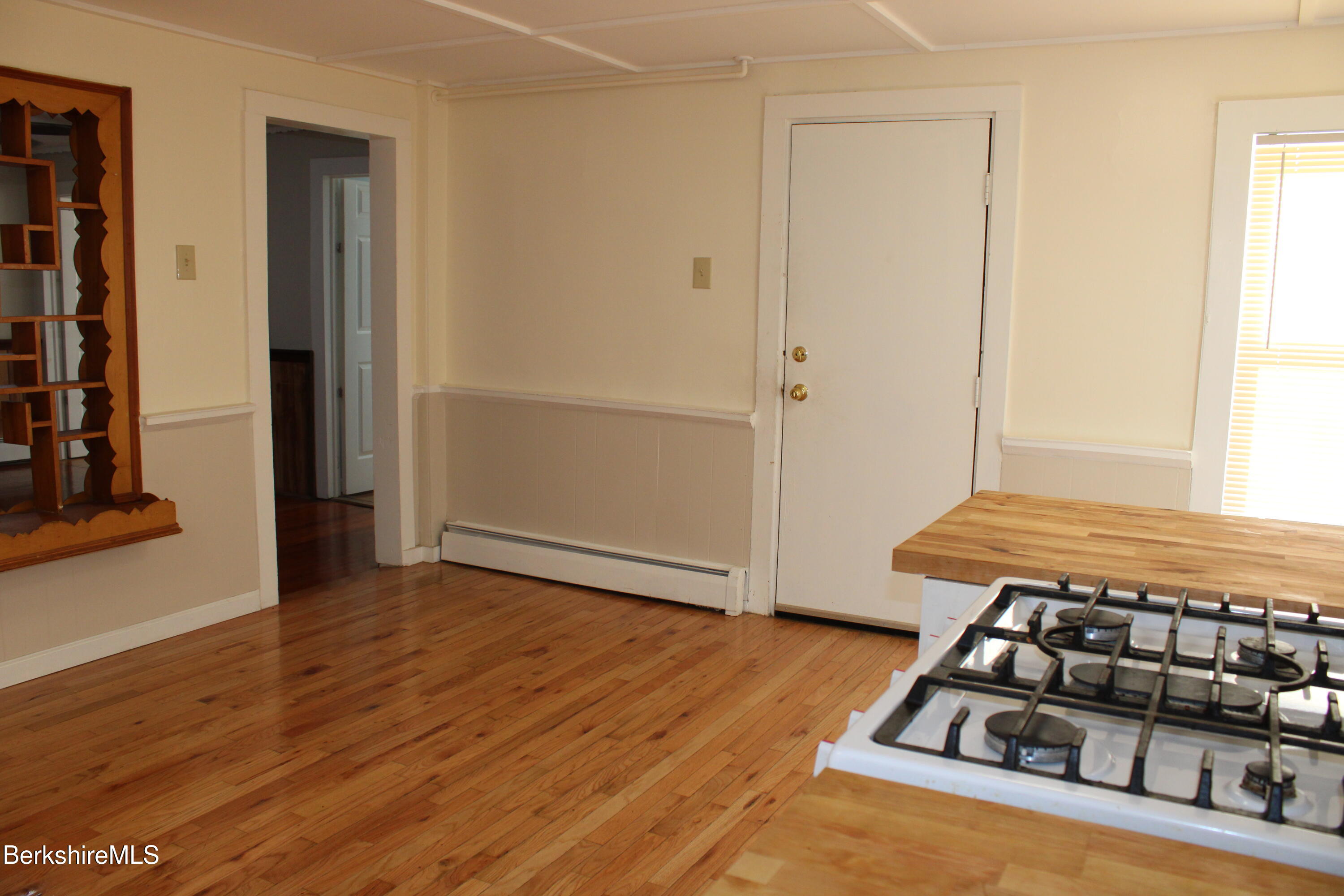 3-5 Pleasant Street Pittsfield, MA 01201 - Photo 10 of 40 a room with wooden floor and shoes