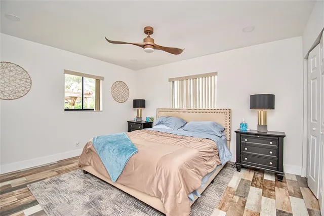 a bedroom with a bed and wooden floor