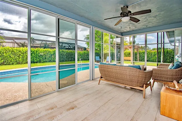 a bedroom with furniture and large windows