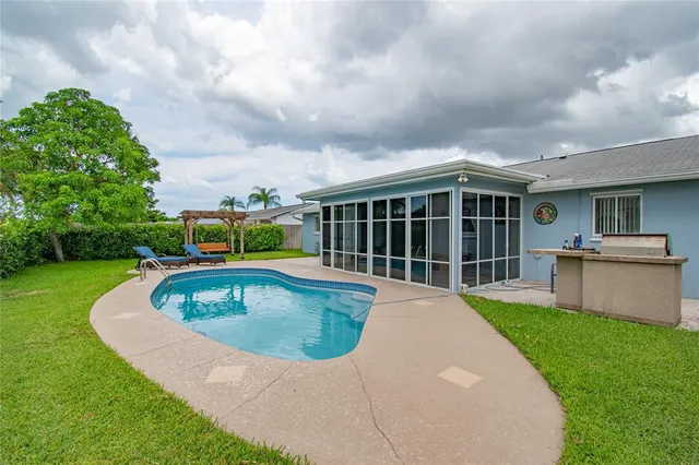 a view of a house with a swimming pool and a yard