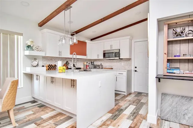 a kitchen with stainless steel appliances granite countertop a sink and cabinets