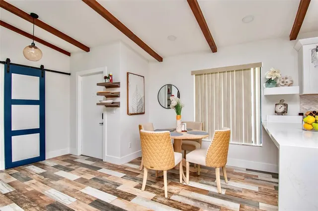 a view of a dining room with furniture and a window