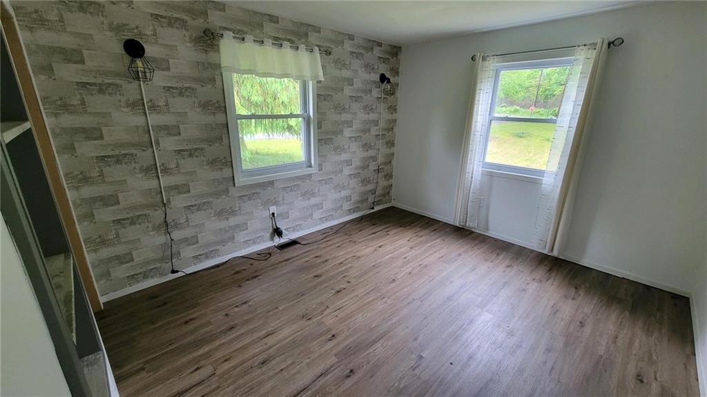14 Bortz Road Stoneboro, PA 16153 - Photo 4 of 14 a view of an empty room with wooden floor and a window