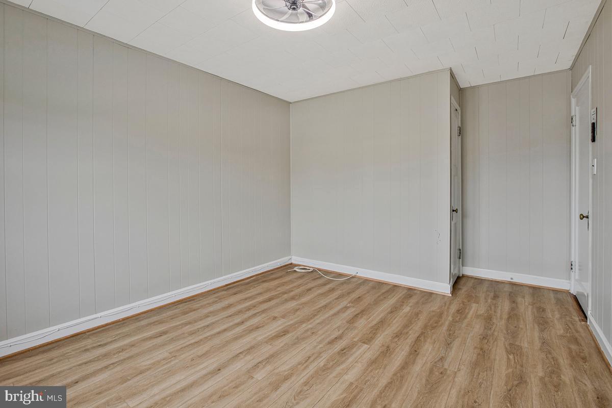 3040 Federal Street Baltimore, MD 21213 - Photo 25 of 41 a view of an empty room with wooden floor and a window