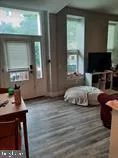 a bedroom with furniture and a flat screen tv