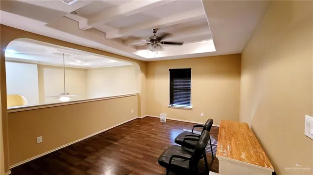 a view of a workspace with furniture and a window