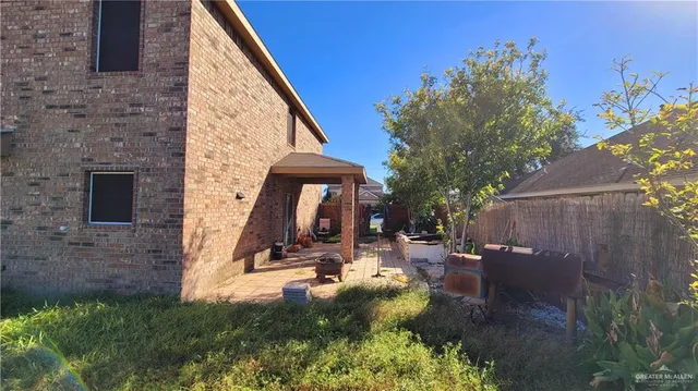 a view of a patio with table and chairs and potted plants