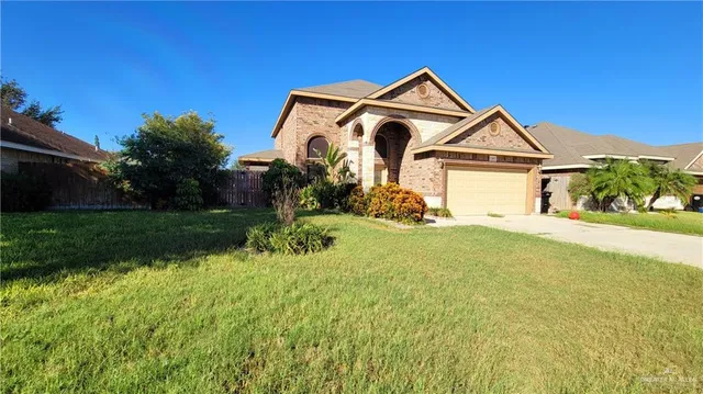 a front view of a house with yard