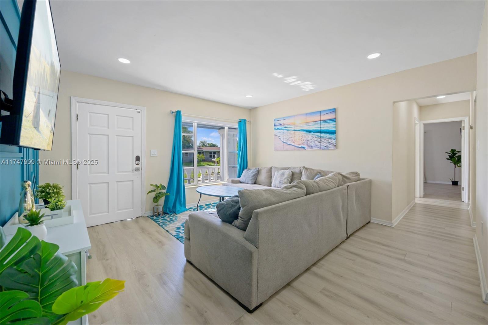 a living room with furniture and a flat screen tv