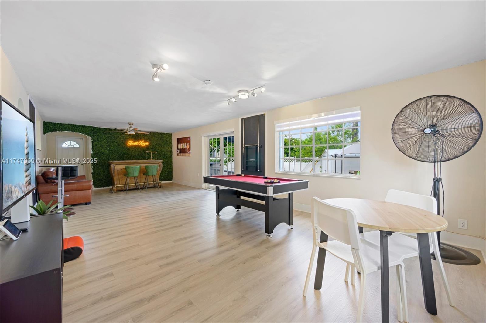 951 Northwest 148th Street Miami, FL 33168 - Photo 13 of 36 a living room with furniture a table and a large window