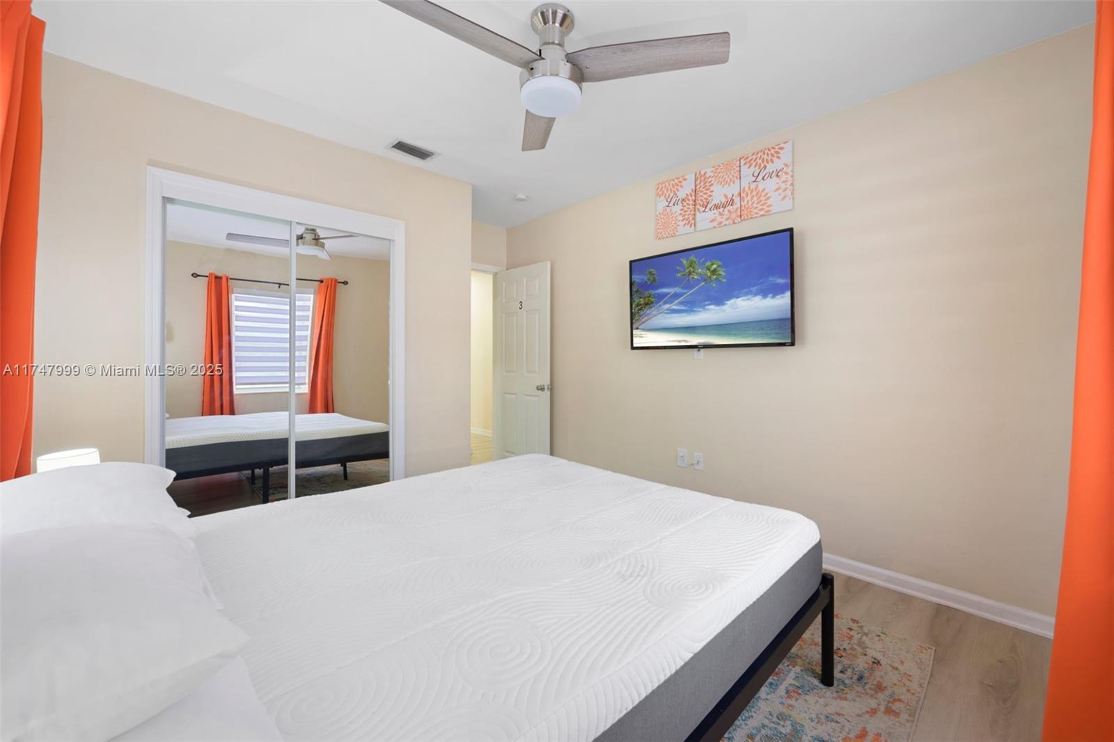 951 Northwest 148th Street Miami, FL 33168 - Photo 21 of 36 a bedroom with a bed and a window