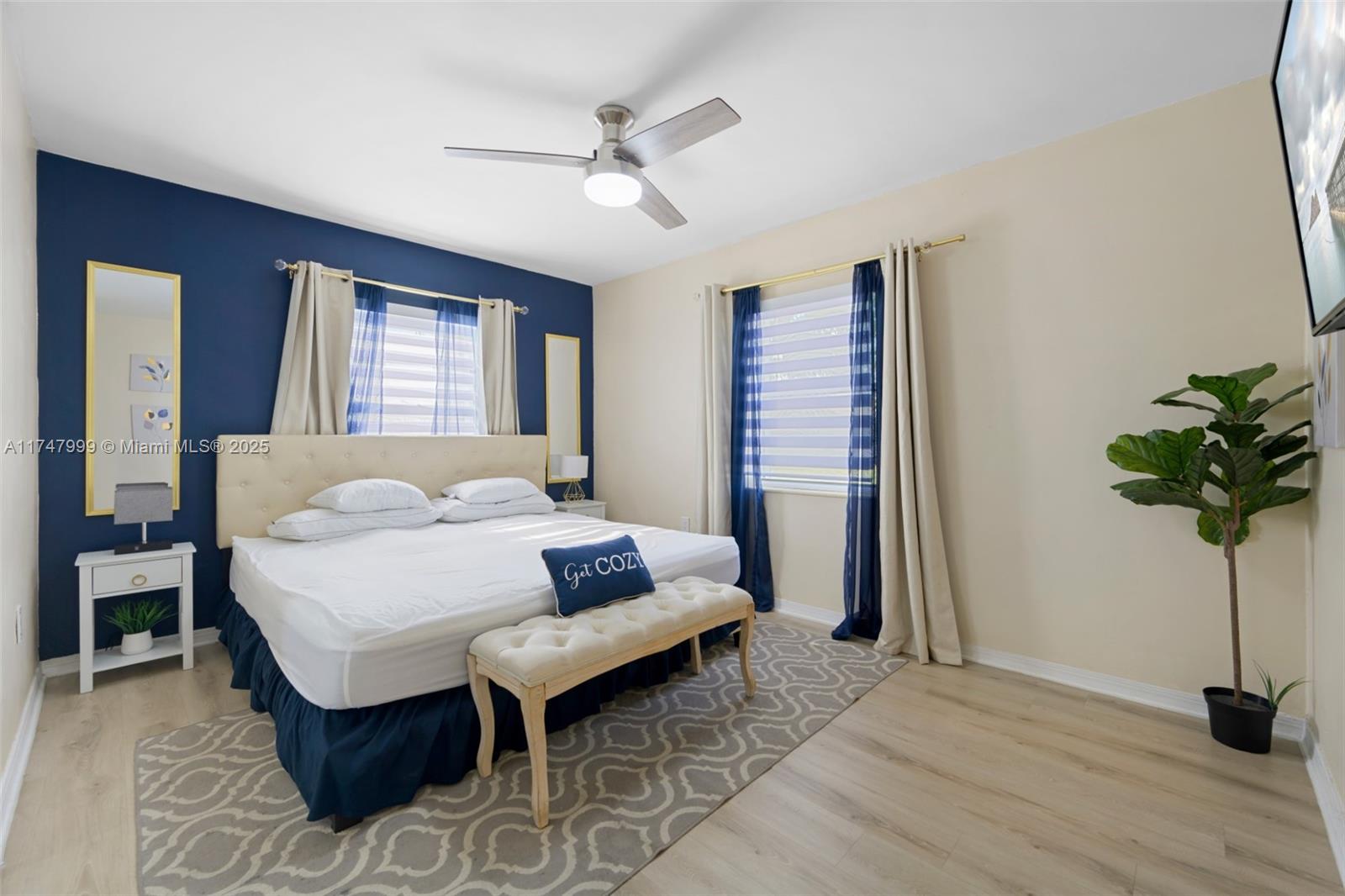 951 Northwest 148th Street Miami, FL 33168 - Photo 23 of 36 a bedroom with a bed a chandelier and potted plant on the table