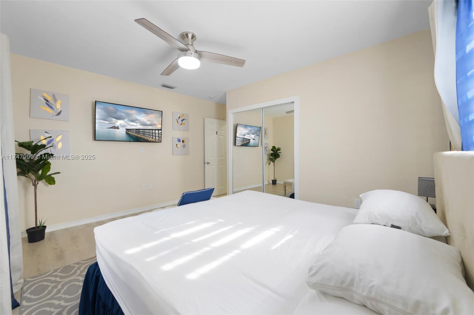 951 Northwest 148th Street Miami, FL 33168 - Photo 24 of 36 a bedroom with a bed and a potted plant