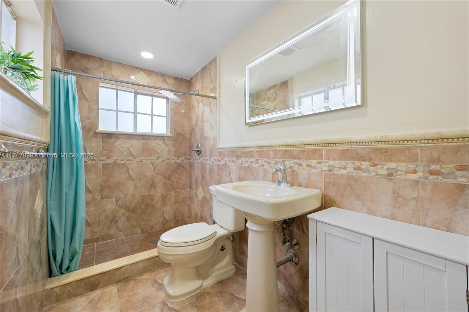 951 Northwest 148th Street Miami, FL 33168 - Photo 25 of 36 a bathroom with a sink a toilet and shower