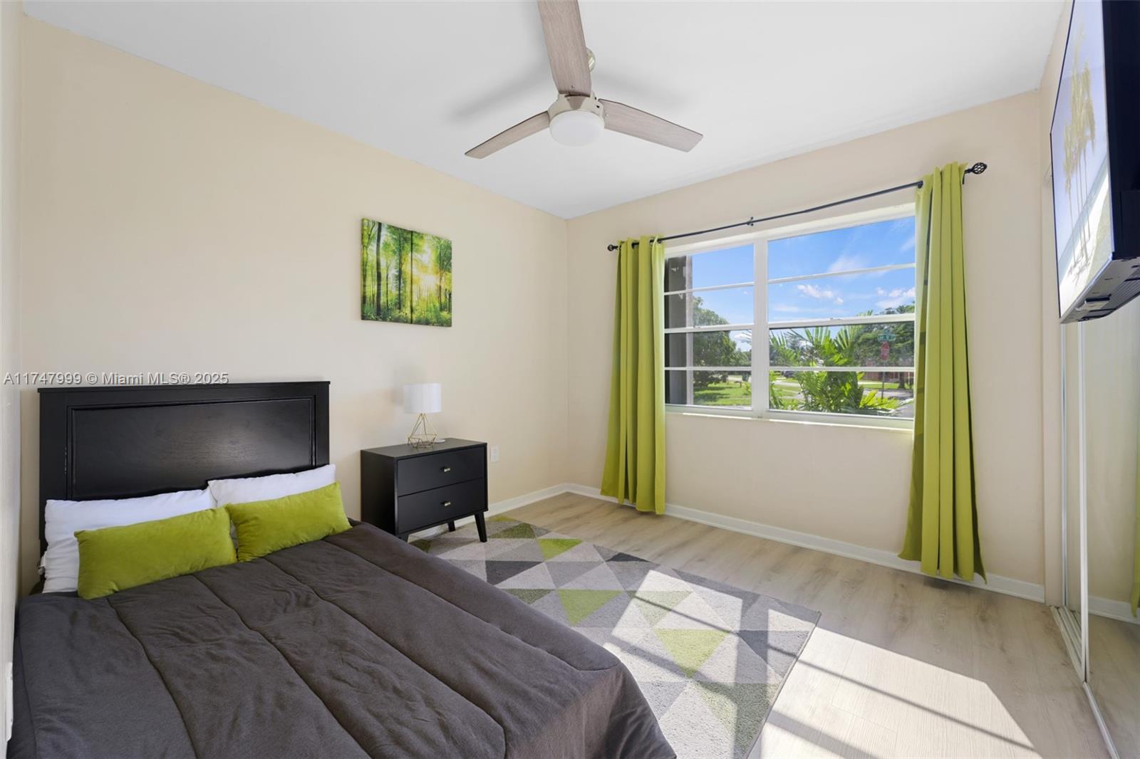 951 Northwest 148th Street Miami, FL 33168 - Photo 26 of 36 a bedroom with a bed and a chandelier