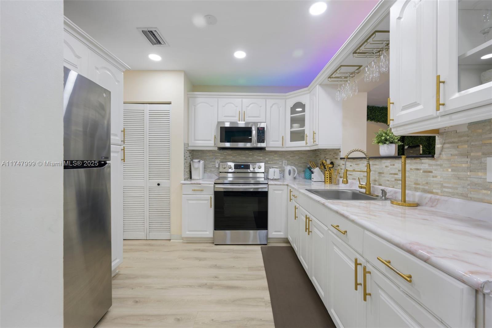 951 Northwest 148th Street Miami, FL 33168 - Photo 3 of 36 a kitchen with stainless steel appliances granite countertop a refrigerator a stove a sink and a microwave