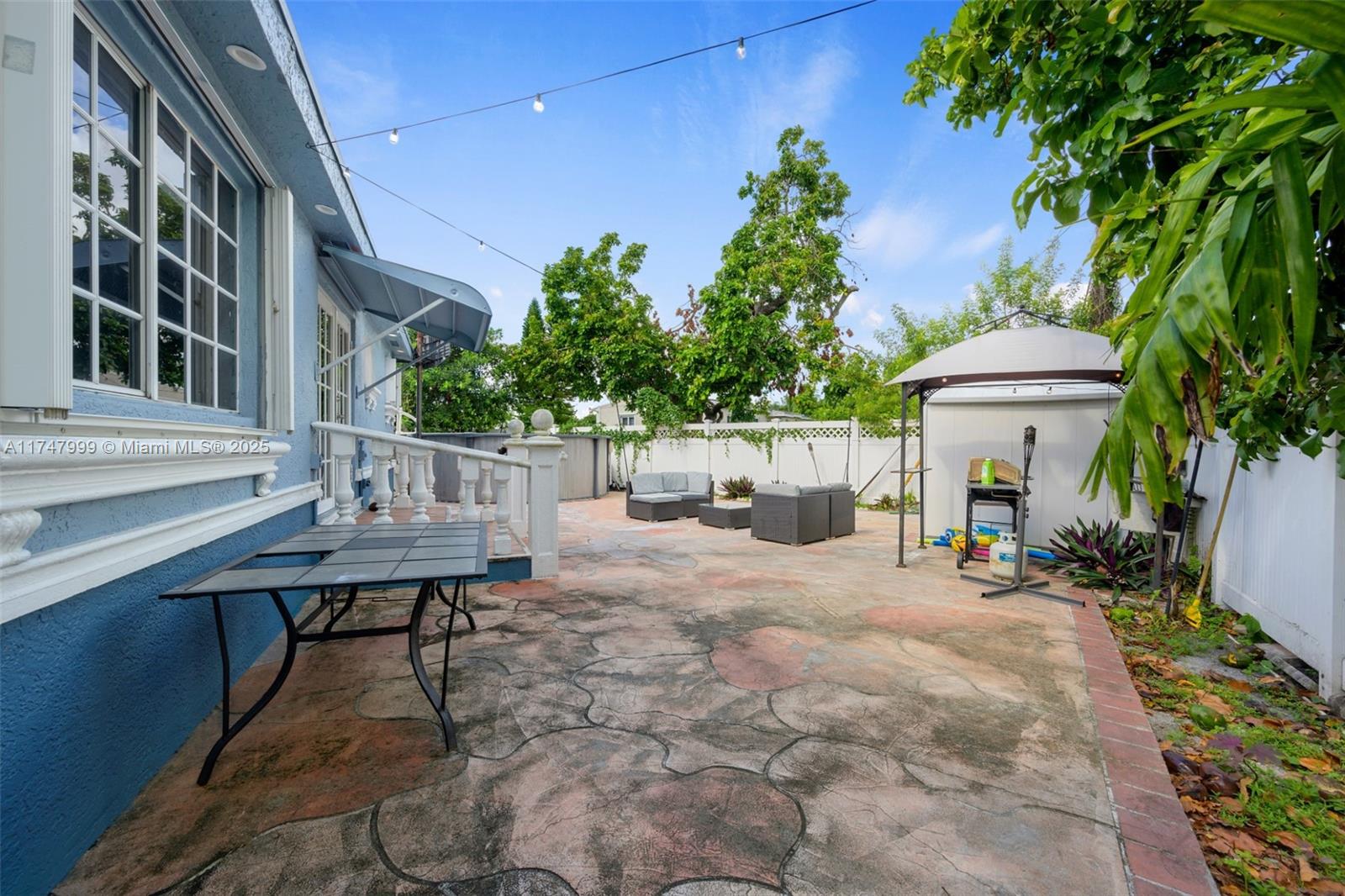 951 Northwest 148th Street Miami, FL 33168 - Photo 31 of 36 a view of a chair and table in backyard of the house