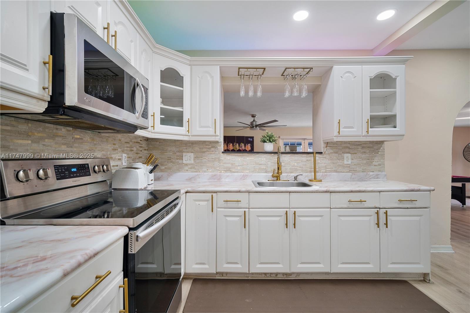 951 Northwest 148th Street Miami, FL 33168 - Photo 4 of 36 a kitchen with stainless steel appliances granite countertop a sink and a stove