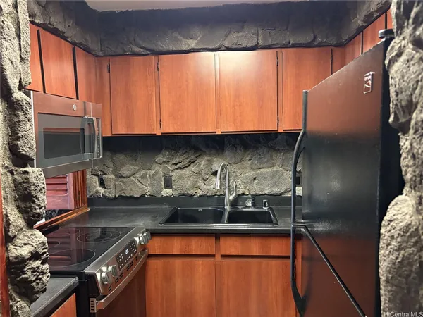 a kitchen with stainless steel appliances granite countertop a sink stove and microwave