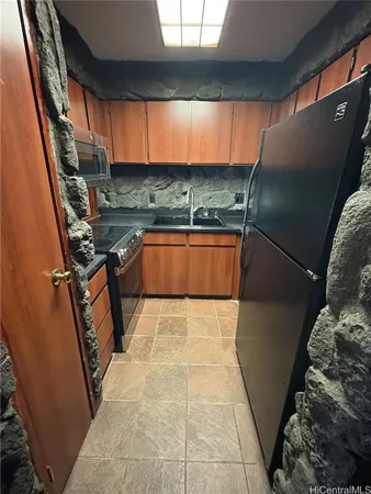 a kitchen with stainless steel appliances granite countertop a sink and a stove