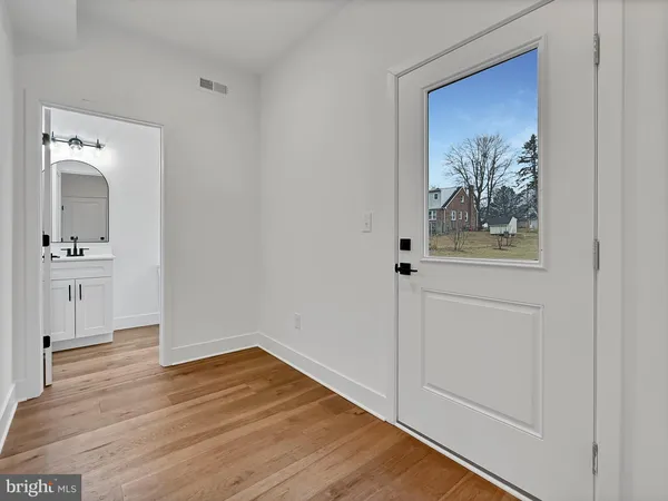 a view of a hallway with wooden floor