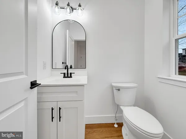 a bathroom with a toilet a sink and mirror