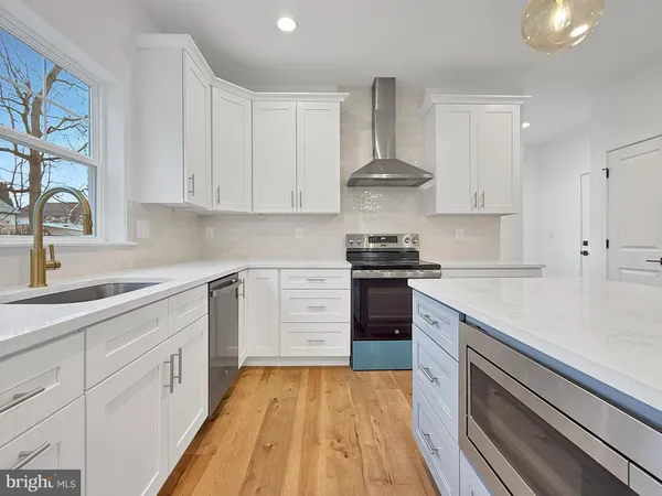 a kitchen with cabinets appliances and a sink