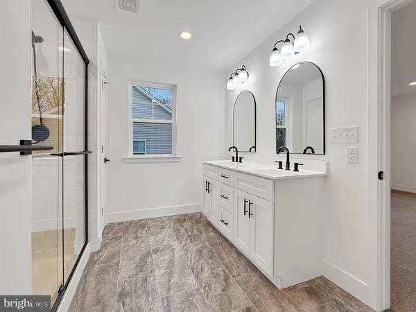 a bathroom with a double vanity sink and mirror