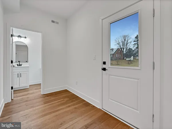 a view of a hallway with wooden floor