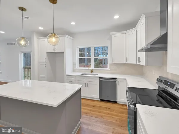 a kitchen with a refrigerator a sink and dishwasher