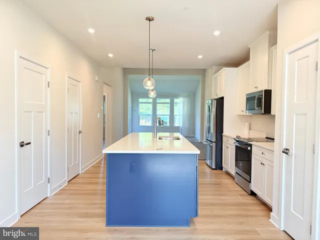 a view of kitchen with sink microwave and stove