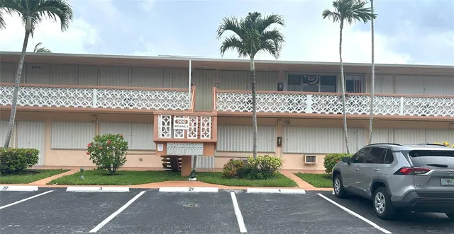 a front view of a house with a garden and a garage