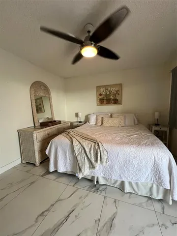 a bedroom with a bed and a painting