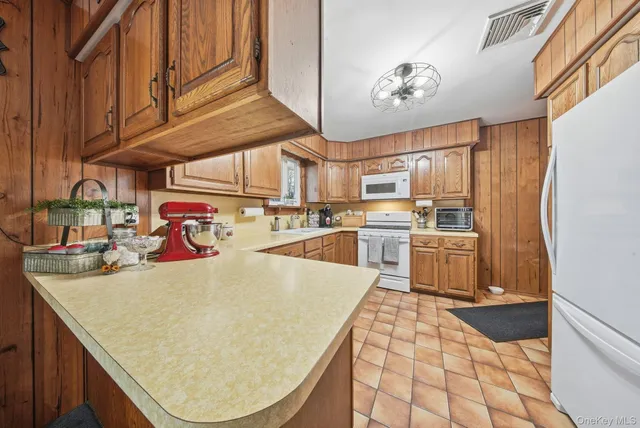 a kitchen with stainless steel appliances granite countertop a sink a stove and cabinets