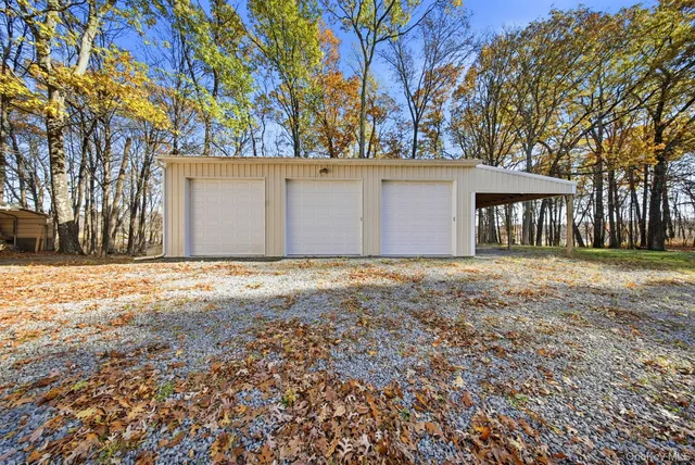 a view of a house with a yard and tree