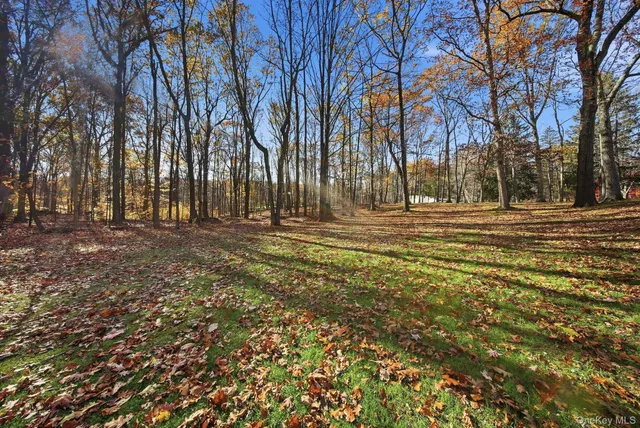 a picture of a room with a white wall and a refrigerator
