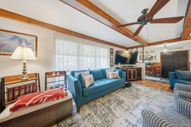 a bedroom with furniture and a wooden floor