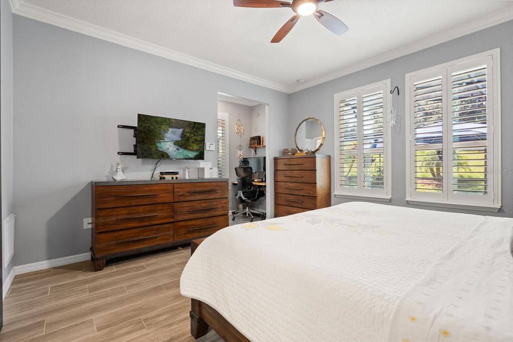 100 Silver Maple Road Groveland, FL 34736 - Photo 13 of 54 a bedroom with a bed and a flat screen tv