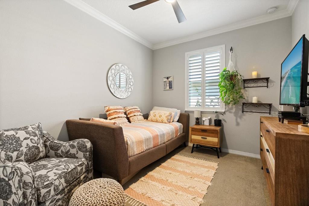 100 Silver Maple Road Groveland, FL 34736 - Photo 15 of 54 a bedroom with bed couch and window