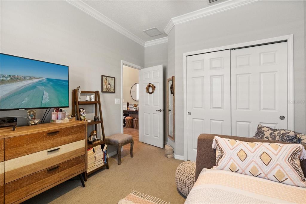 100 Silver Maple Road Groveland, FL 34736 - Photo 16 of 54 a bedroom with furniture and a flat screen tv