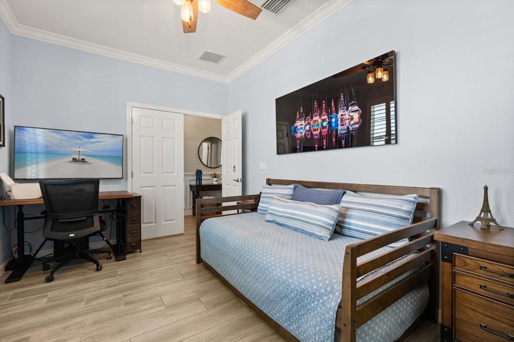 100 Silver Maple Road Groveland, FL 34736 - Photo 18 of 54 a bedroom with furniture and a flat screen tv