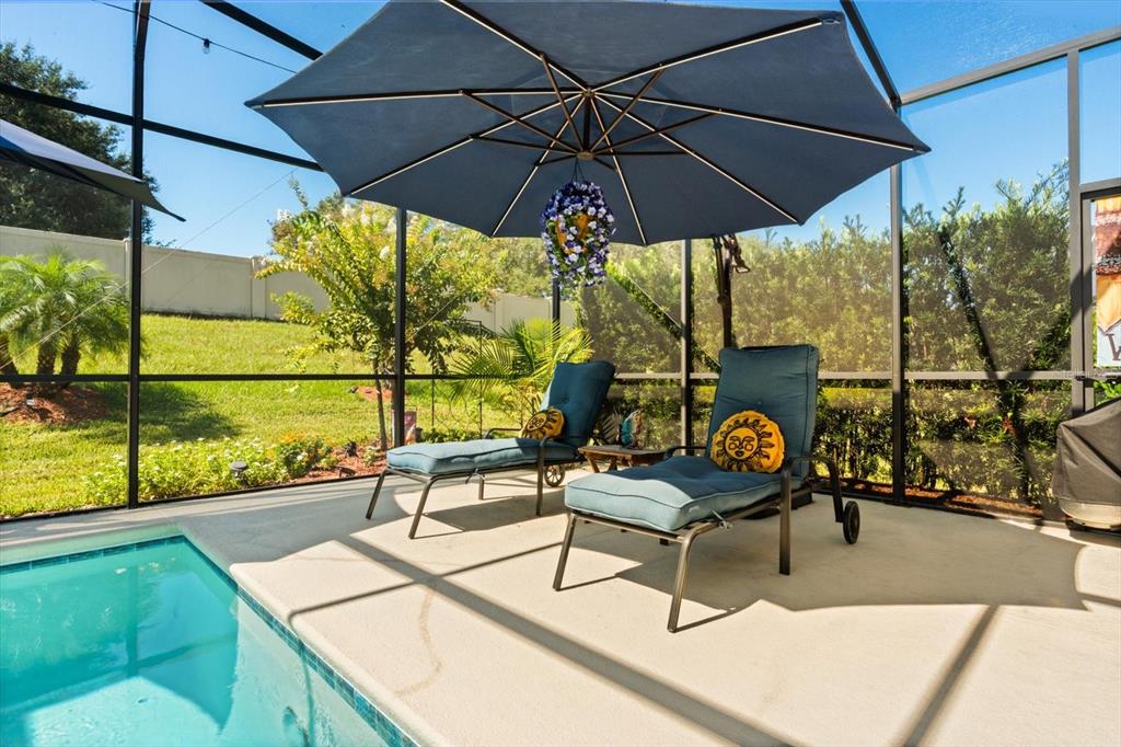 100 Silver Maple Road Groveland, FL 34736 - Photo 21 of 54 a view of an outdoor sitting area with furniture and umbrella