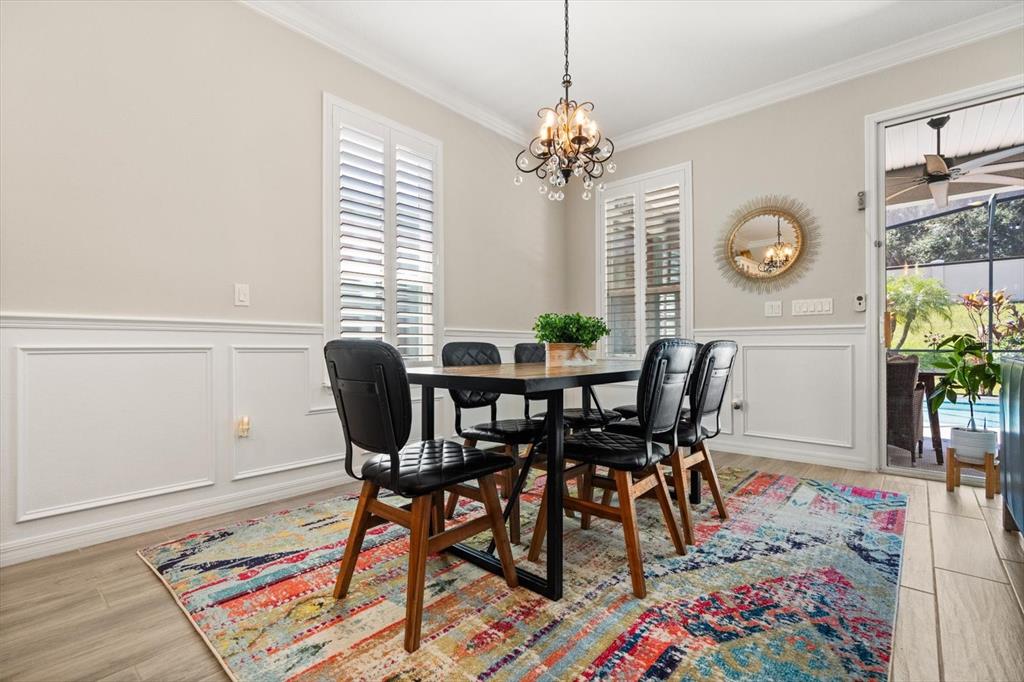 100 Silver Maple Road Groveland, FL 34736 - Photo 7 of 54 a view of a dining room with furniture and a chandelier