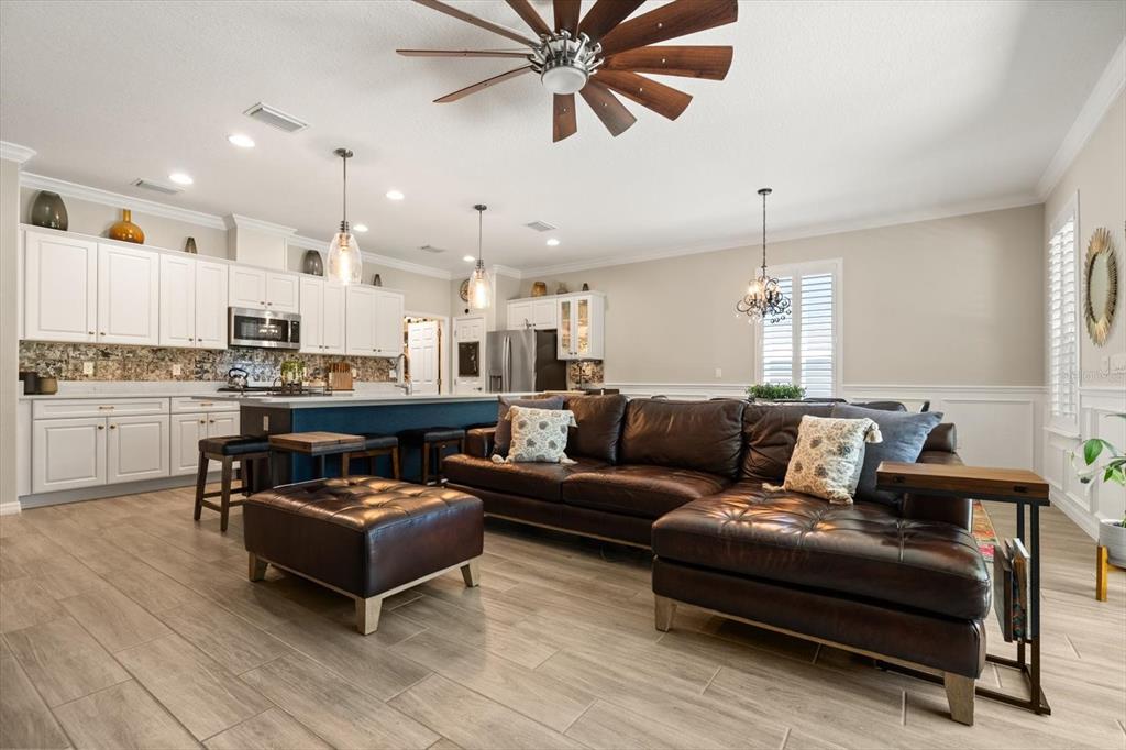 100 Silver Maple Road Groveland, FL 34736 - Photo 8 of 54 a living room with furniture and kitchen view