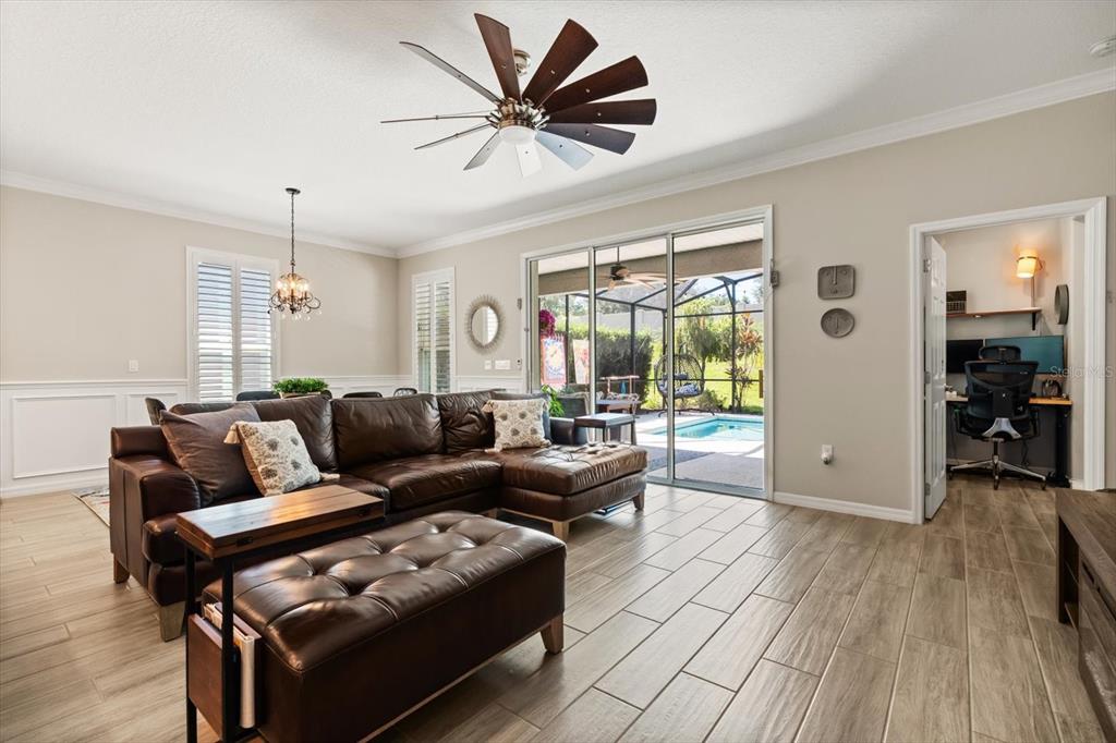 100 Silver Maple Road Groveland, FL 34736 - Photo 9 of 54 a living room with furniture and wooden floor
