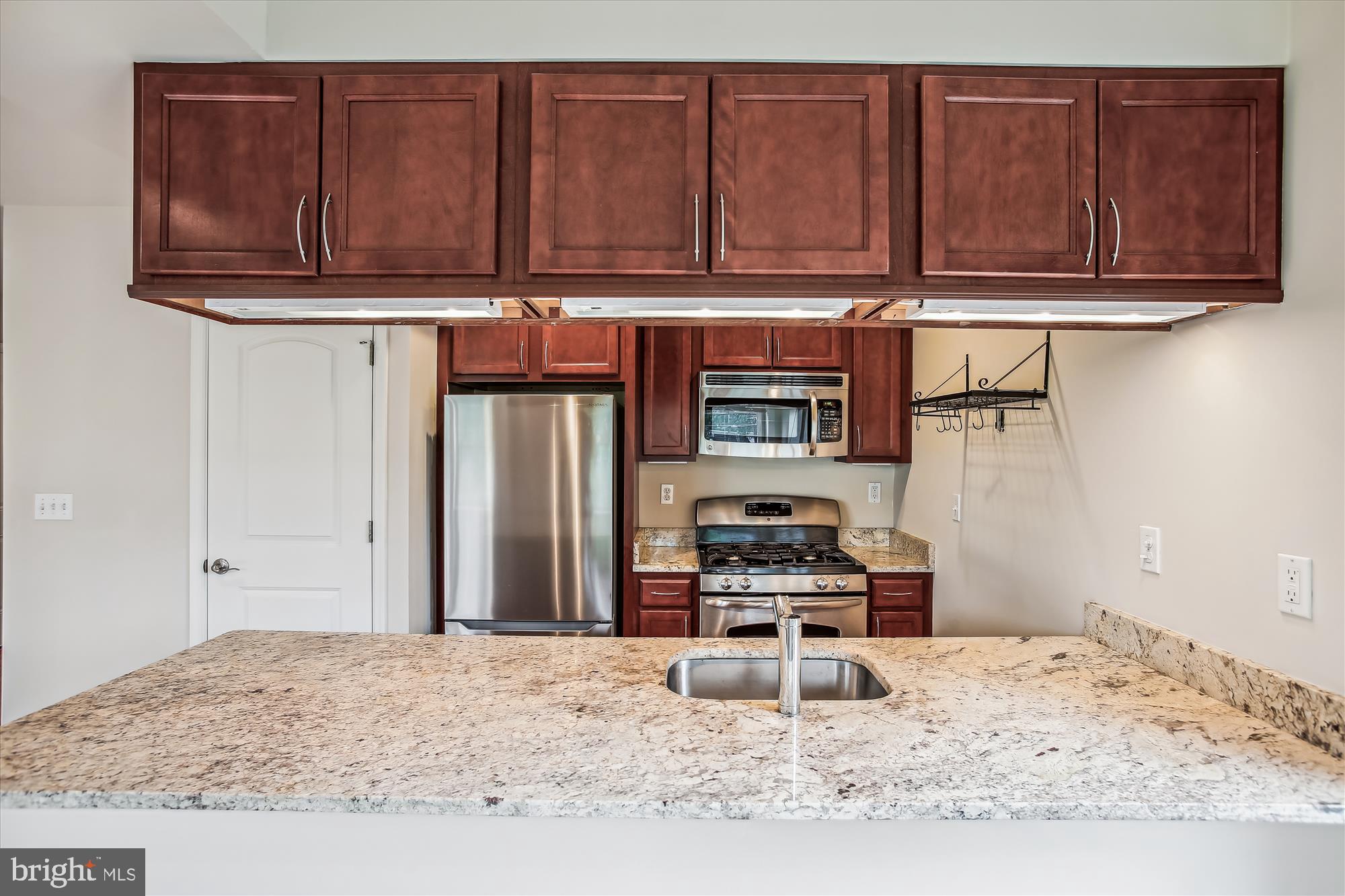 922 Madison Street Northwest, Unit 201 Washington, DC 20011 - Photo 11 of 34 a kitchen with stainless steel appliances granite countertop a stove a refrigerator and cabinets